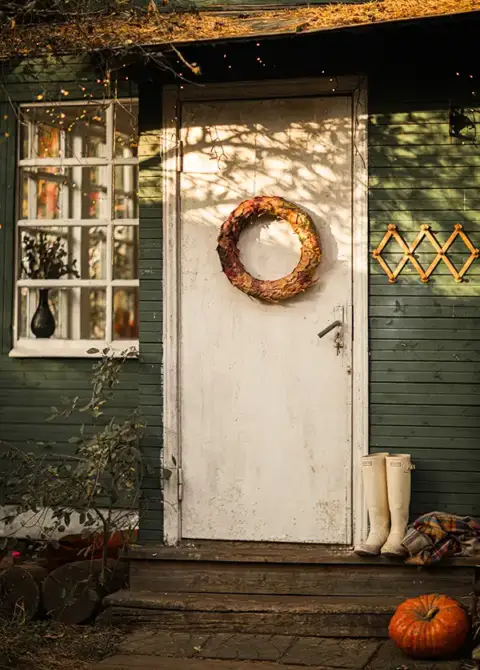Fall is in the air, as this home's exterior door exhibits an autumn wreath.